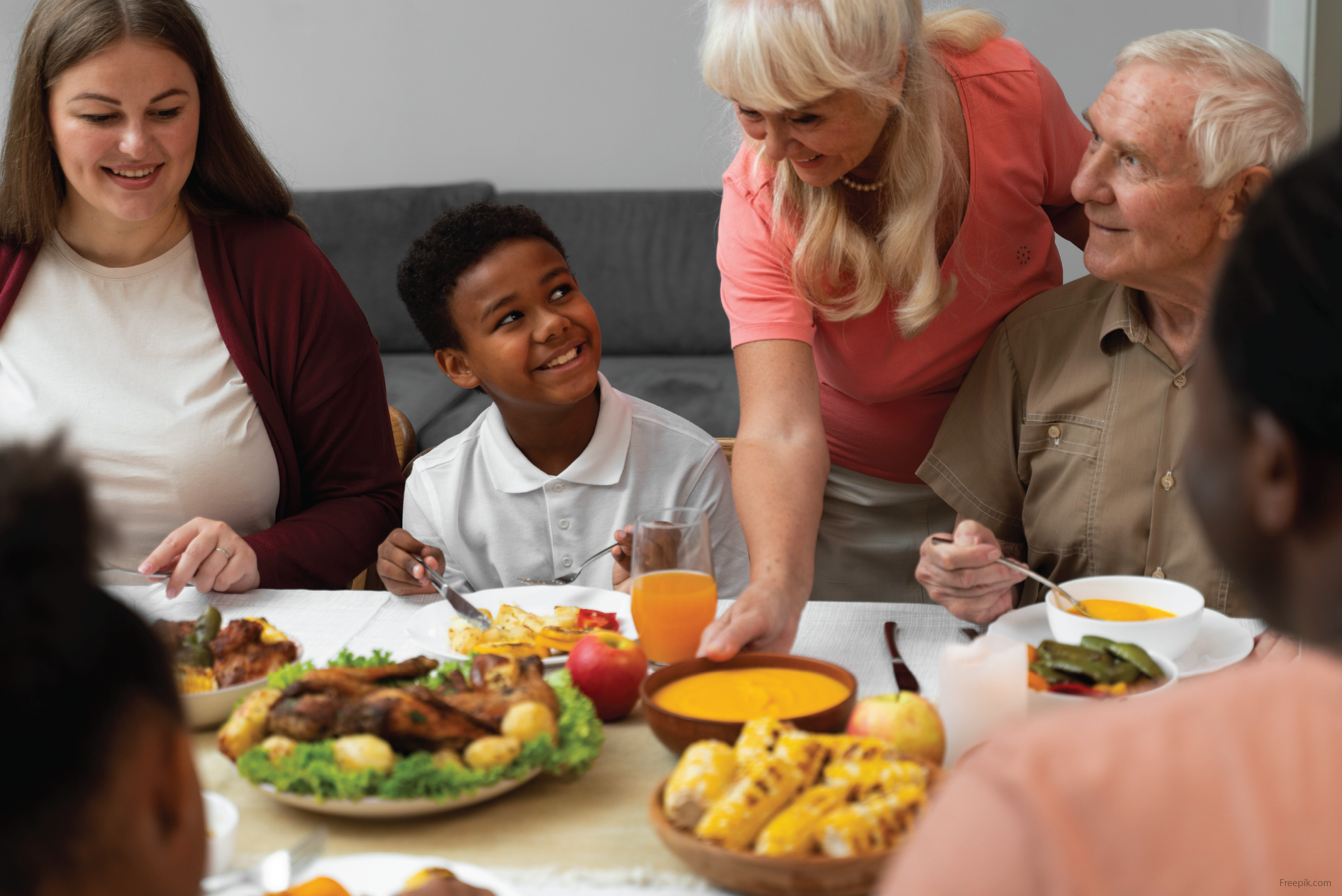 Intergenerational and multi-racial family enjoying dinner